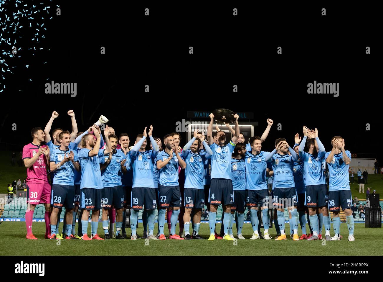 Sydney FC captain Alex Wilkinson (4) holds up the Premier's Plate celebrating with the team Stock Photo