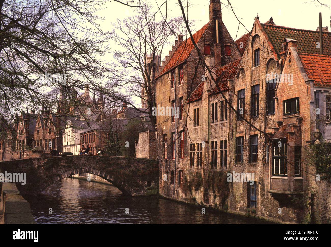 APR 1984: Buildings lining the Groenerei Canal and a bridge in Bruges, Belgium Stock Photo