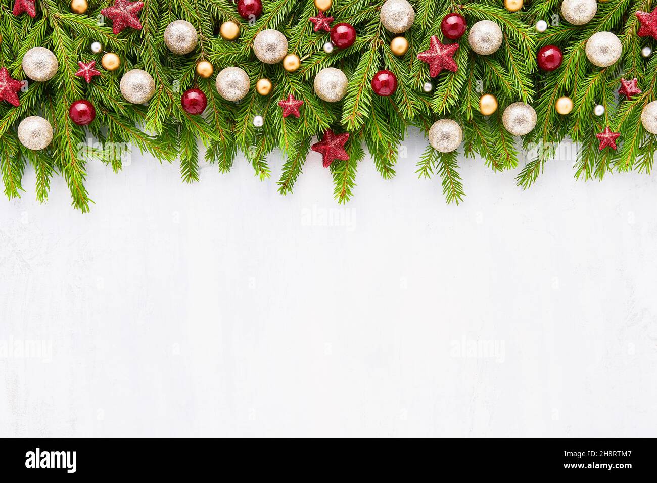 Christmas background. Christmas decoration on fir tree branches on a light background with copy space. Top view, copy space for text. Stock Photo