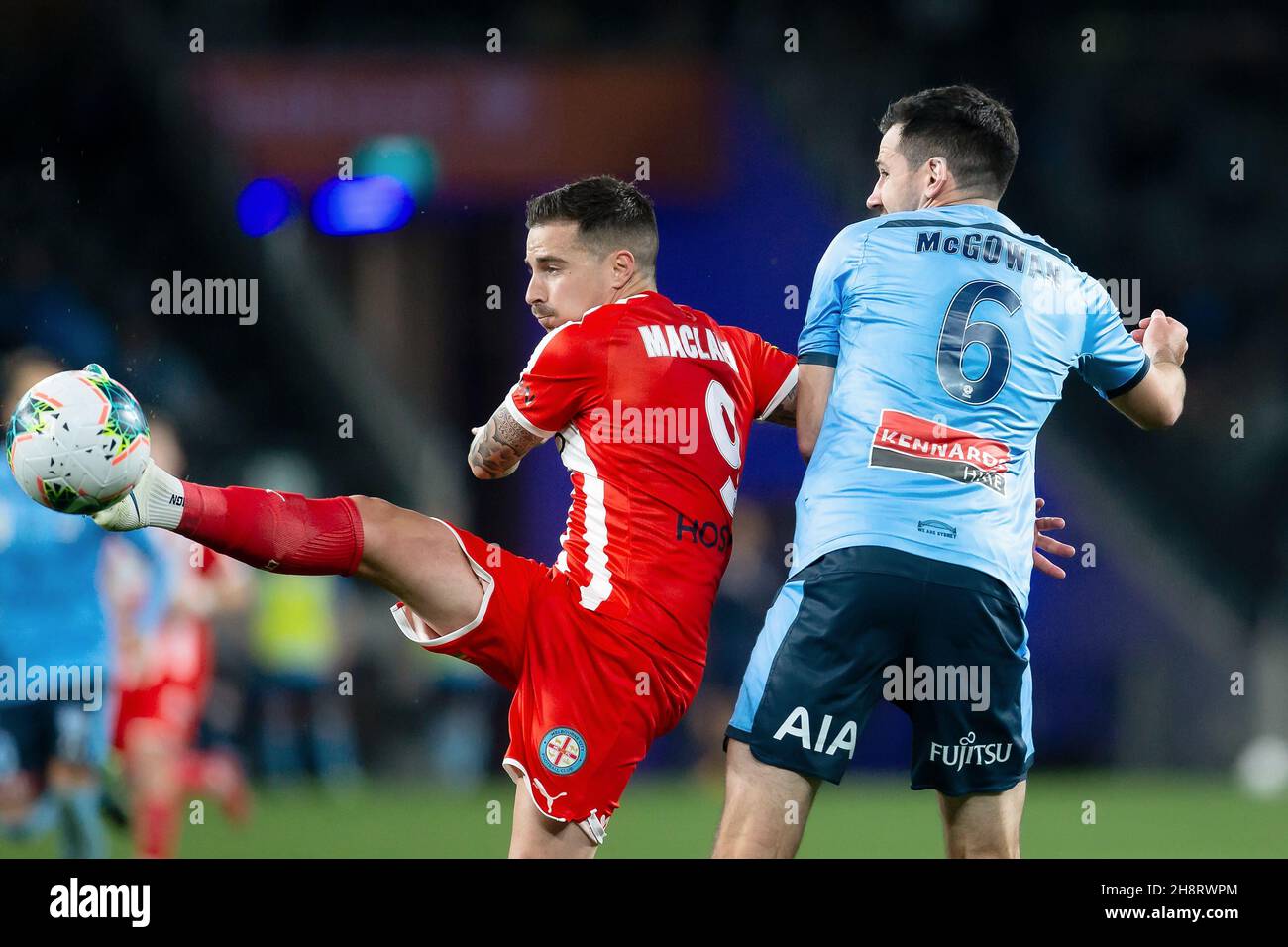Melbourne City forward Jamie Maclaren (9) passes the ball under pressure from Sydney FC defender Ryan McGowan (6) (Photo by Damian Briggs/ Speed Media) Stock Photo