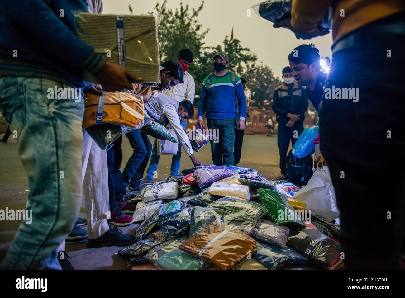 Ghaziabad, India. 01st Dec, 2021. Indian street vendor seen selling readymade garments near Anand vihar bus terminal.In 2020-21 street vending business was badly hit due to the coronavirus. Credit: SOPA Images Limited/Alamy Live News Stock Photo