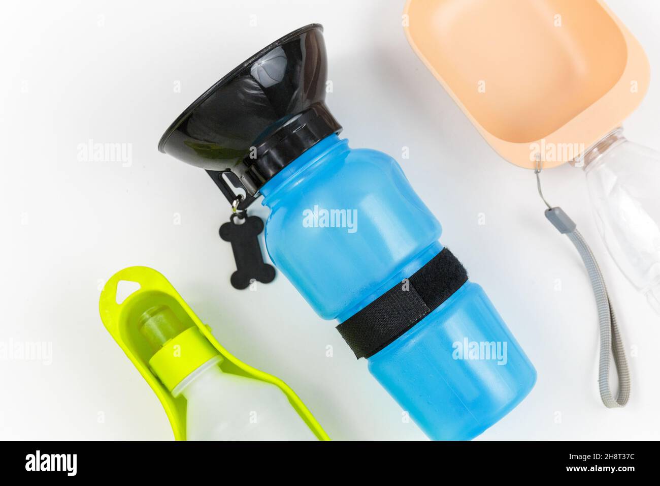 Set of bottles for dogs to drink water outside on white background