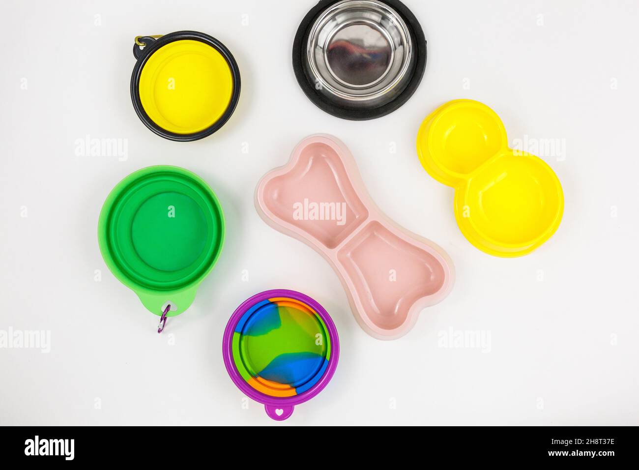 Set of multicolored bowls for food and water for cats and dogs. Bowls