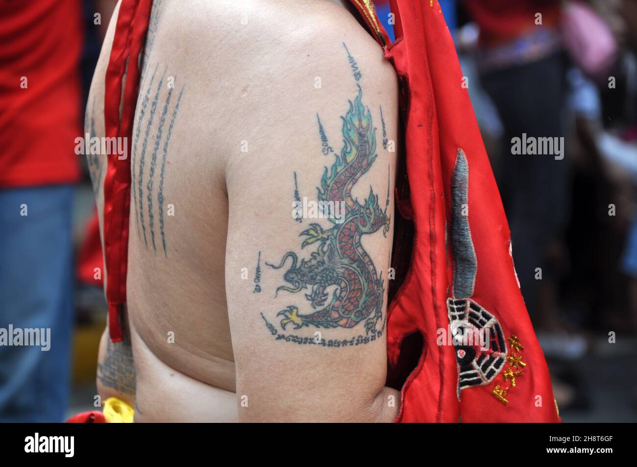 A dragon tattoo on the upper arm of a monk at the Cap Go Meh event in ...