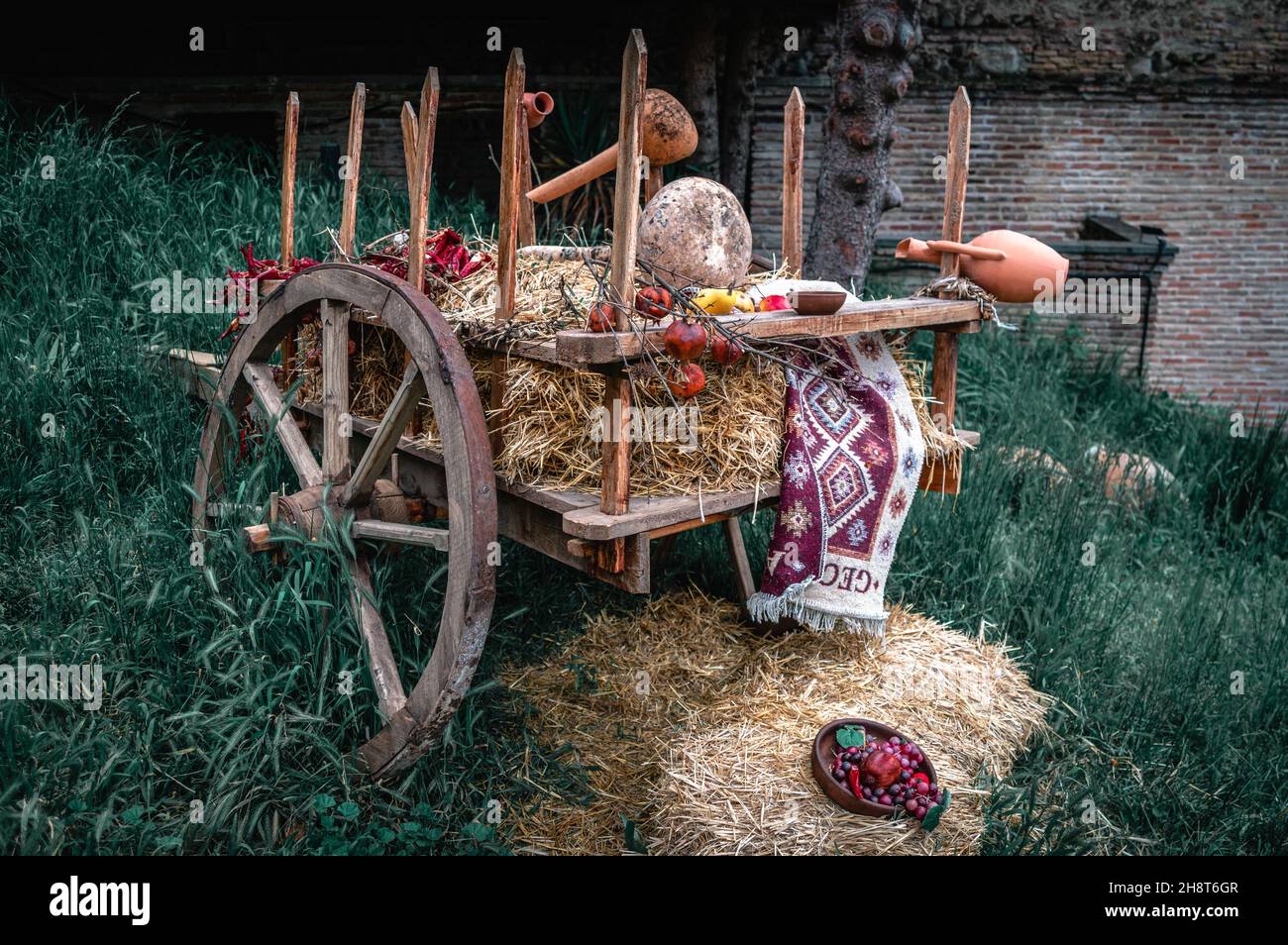 Wooden cart loaded with hay in the town of Signagi. Kakheti Province, Georgia. Stock Photo