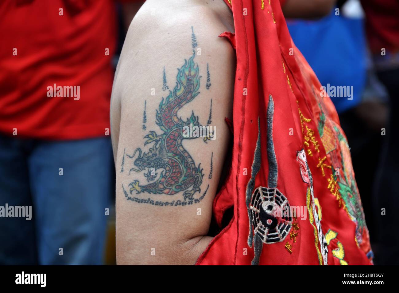 A dragon tattoo on the upper arm of a monk at the Cap Go Meh event in ...
