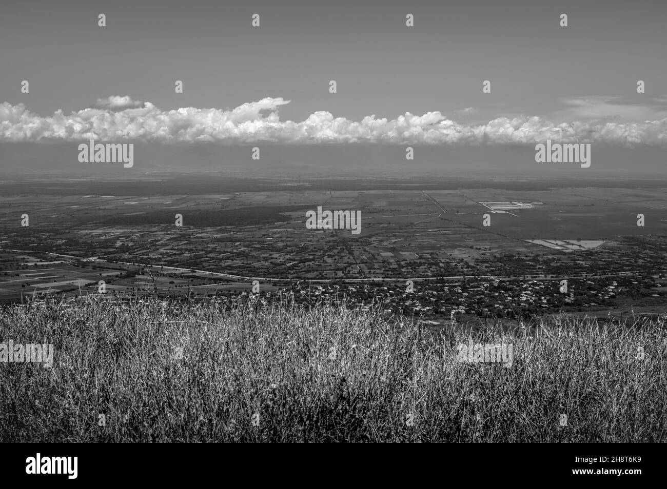 Scenic view of everlasting fields against cloudy skies in the town of Signagi. Kakheti Province, Georgia. Black and white. Stock Photo