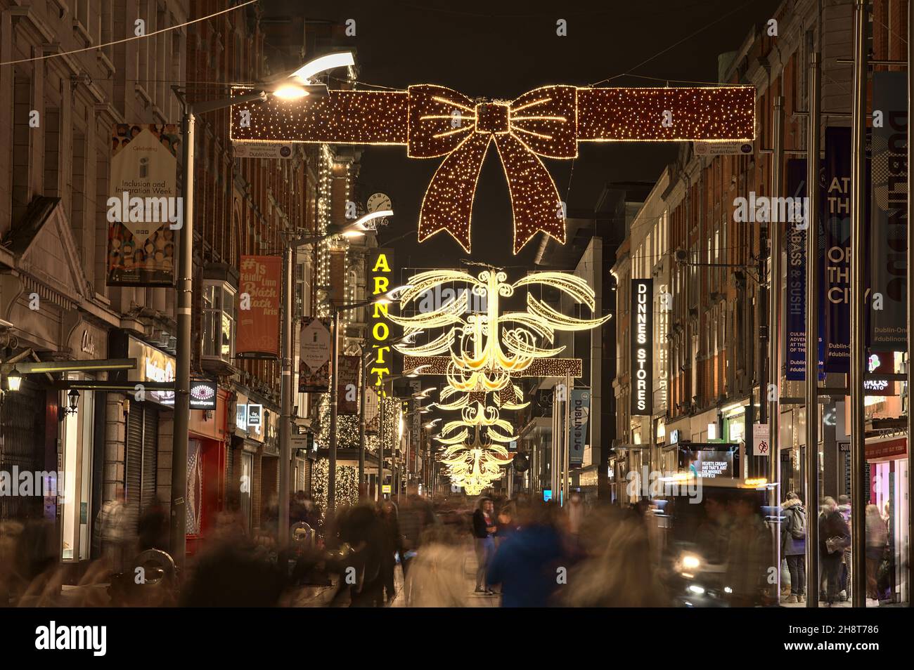 Dublin, Ireland - November 13, 2021: Beautiful view of festive Christmas lights and decorated Arnotts store on busy Henry Street during COVID-19 Stock Photo