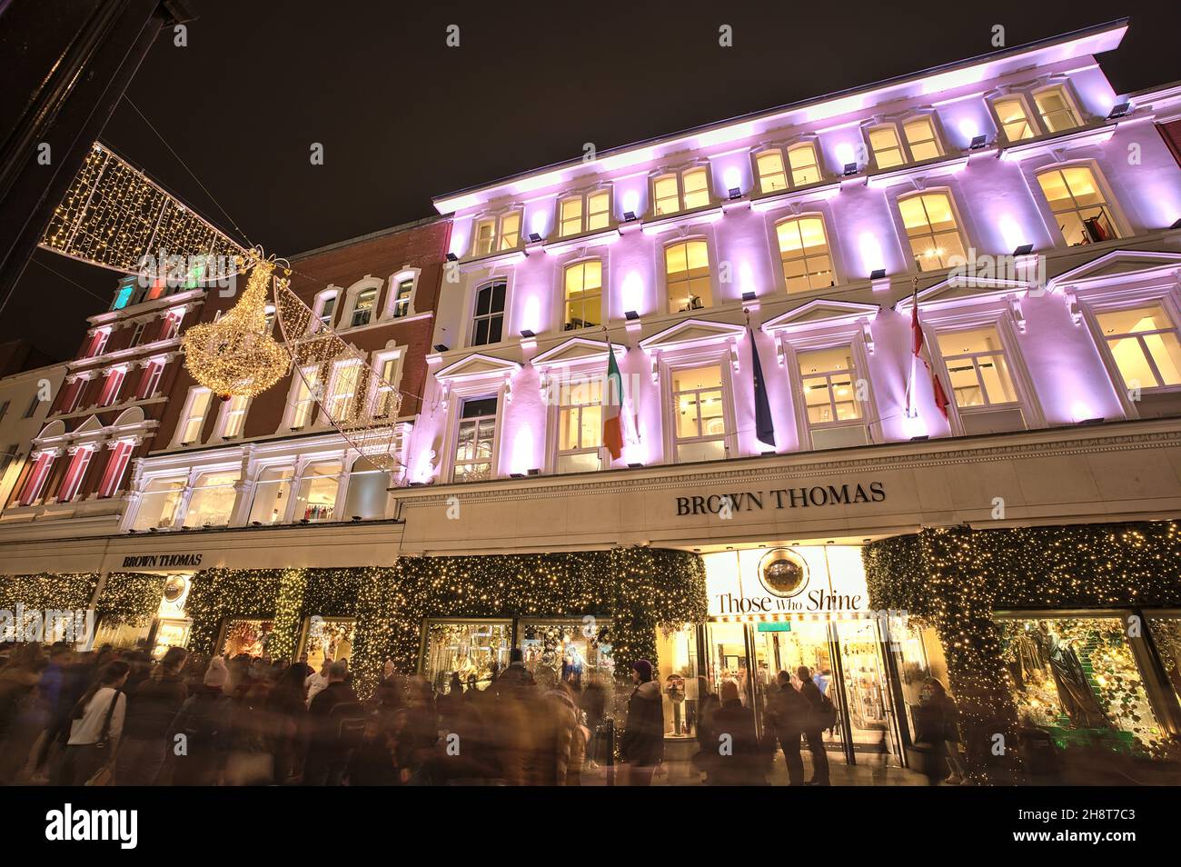 Dublin, Ireland - November 13, 2021: Beautiful evening wide angle view of Brown Thomas hotel decorated with Christmas lights on crowded Grafton Street Stock Photo