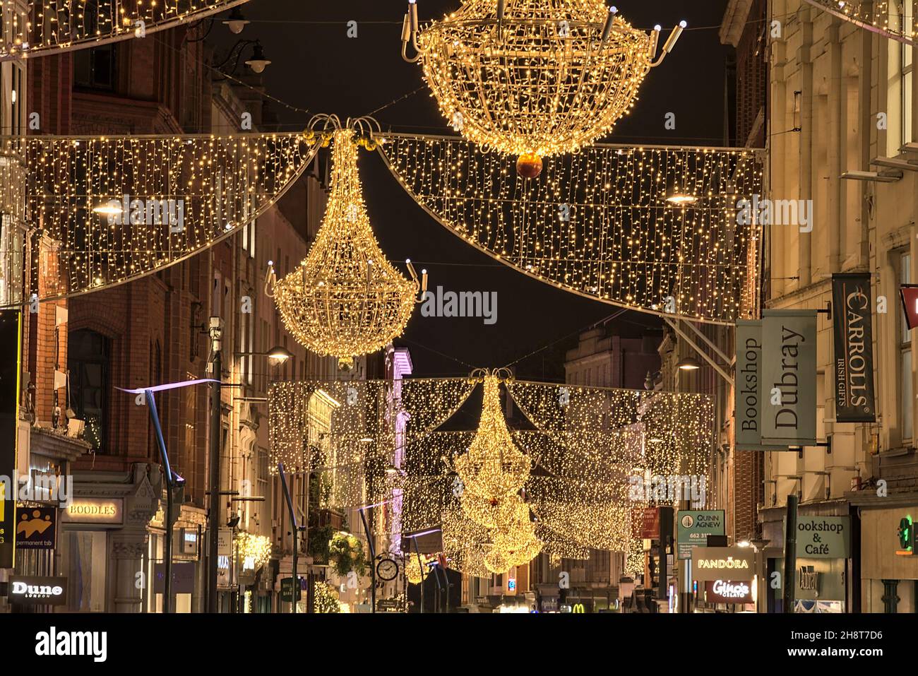 Dublin, Ireland - November 13, 2021: Closeup evening view of Christmas lights decorations on Grafton Street. Crowded street during COVID pandemic Stock Photo