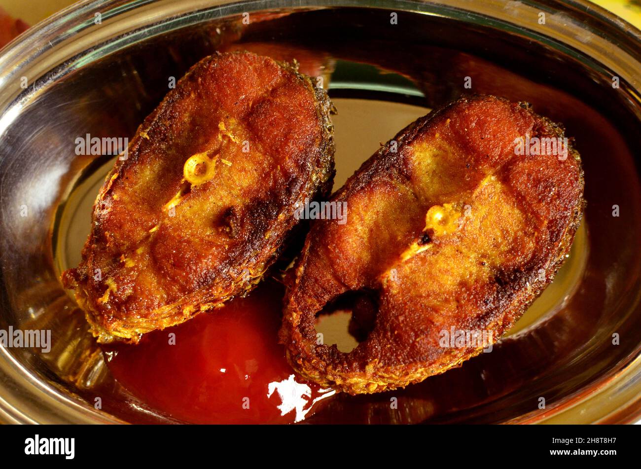 Fried delicious fish of Bengalis , Fish Fry , Fried fish with red chilli powder Stock Photo