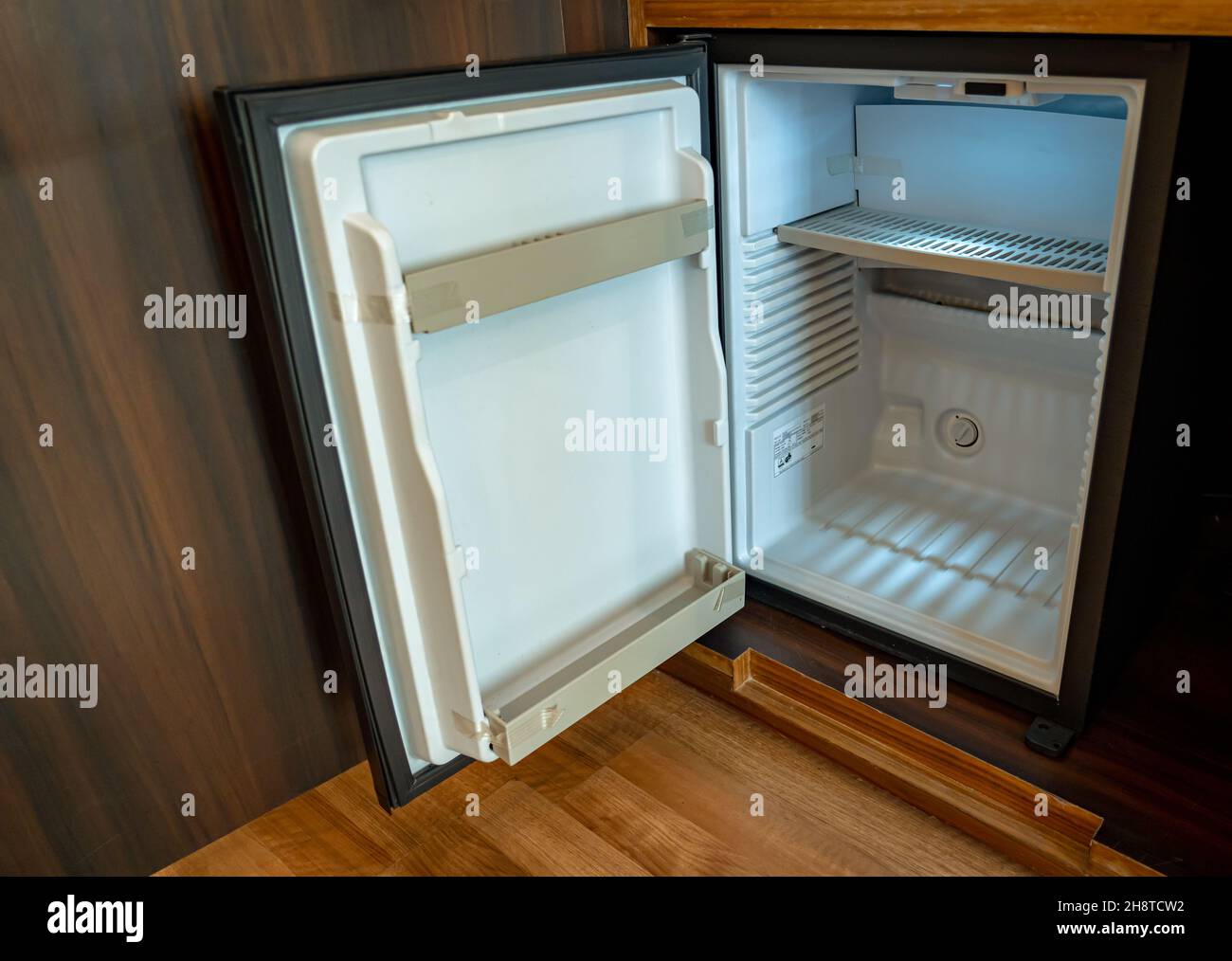 A small empty refrigerator with its door open. Stock Photo