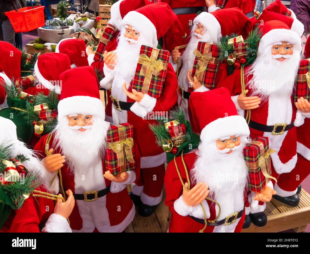 Display of Christmas decorations of Father Christmas or Santa Claus in a garden centre shop for the Christmas sale market Stock Photo