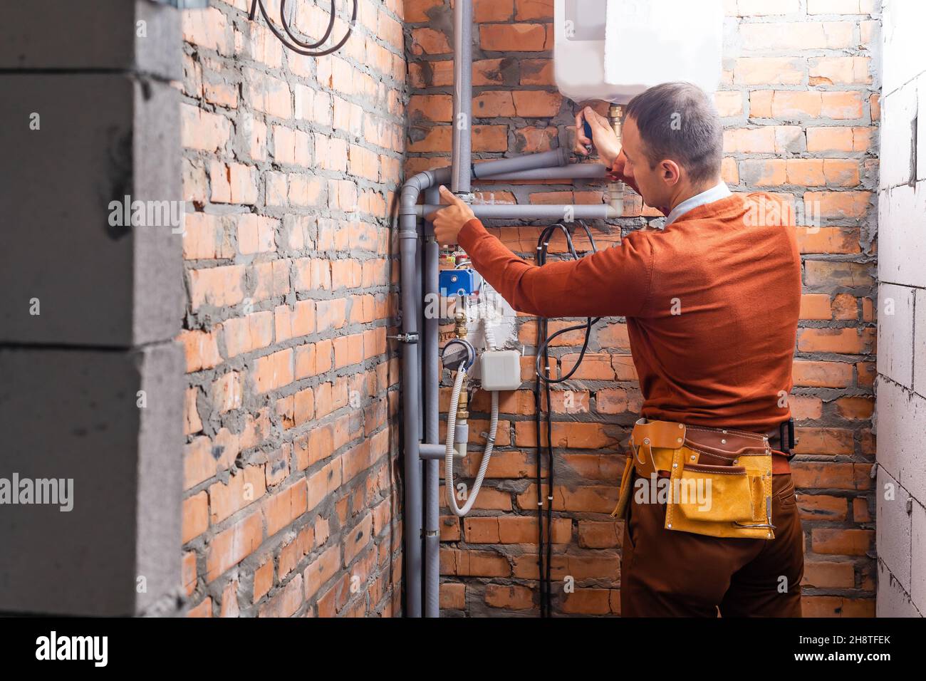 a plumber engineer repairing pipes at work Stock Photo Alamy