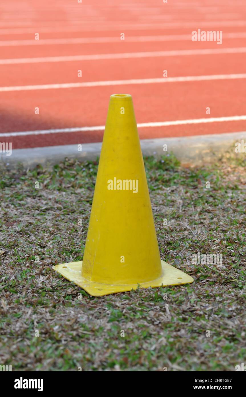 The yellow traffic cone is on the edge of the race track Stock Photo
