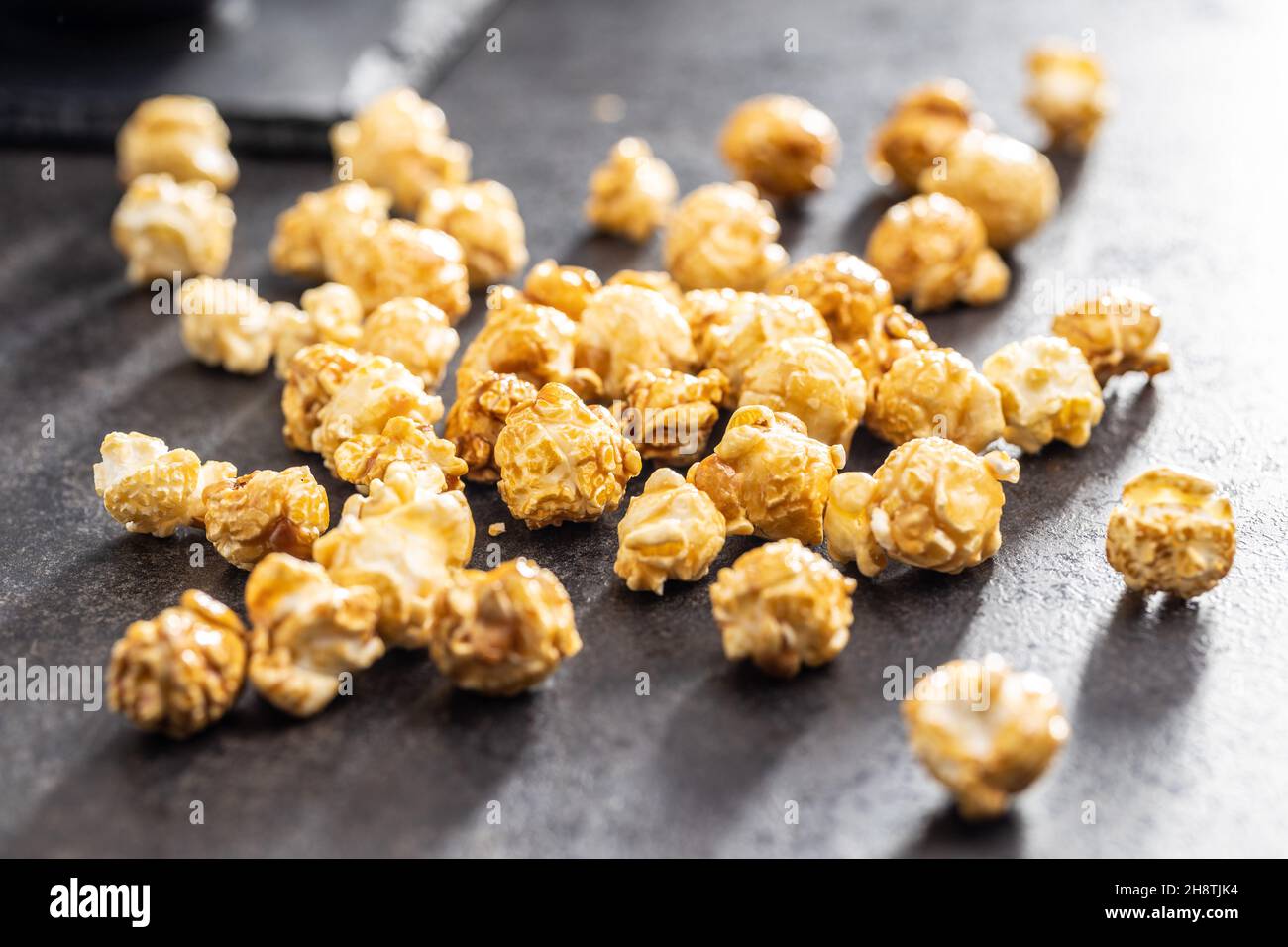 Sweet caramel popcorn on table. Stock Photo