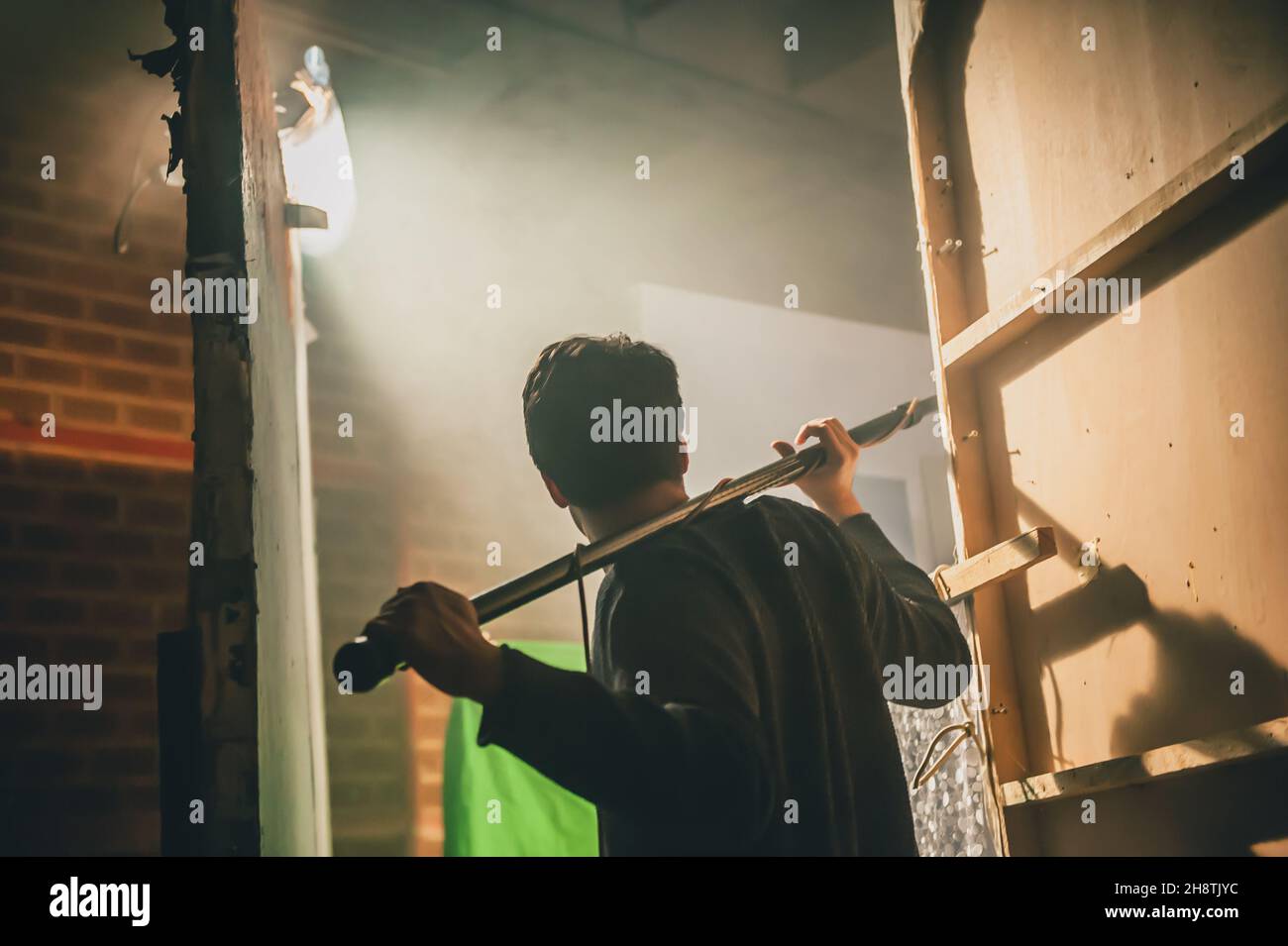 Behind the scene. Sound boom operator hold microphone fisher on the set