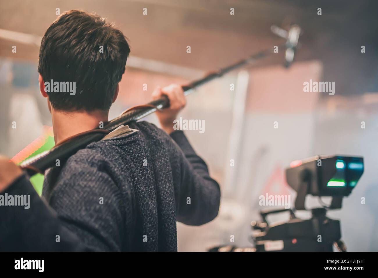 Behind the scene. Sound boom operator hold microphone fisher on the set