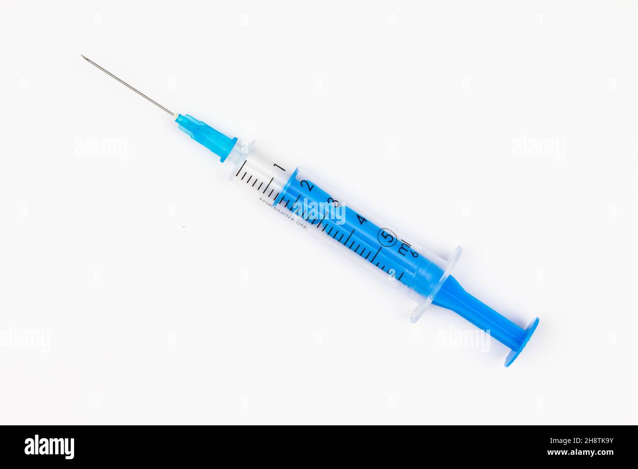 Blue medical disposable syringe for injection on a white background