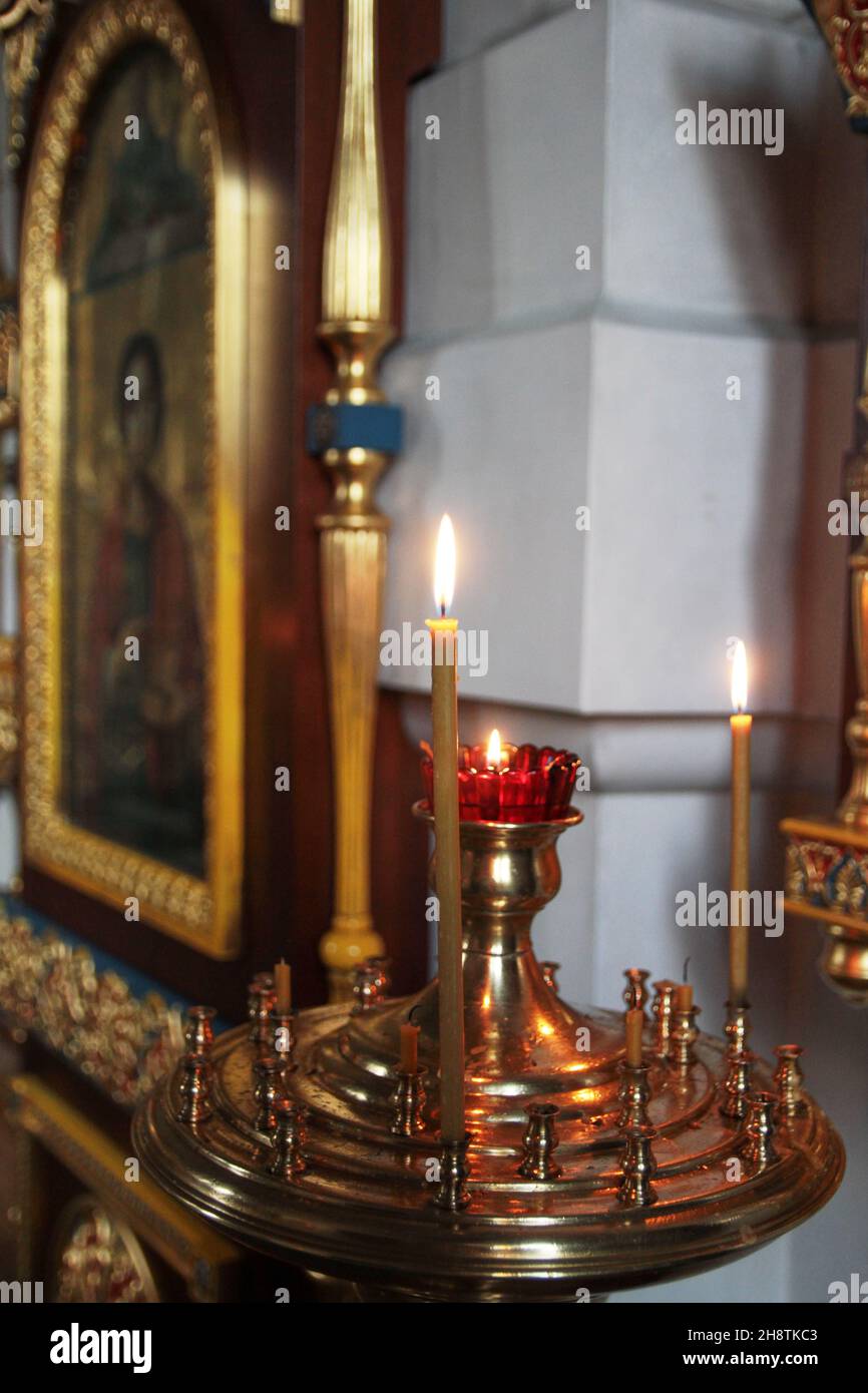 One burning candle in an Orthodox church symbol of christianity Stock
