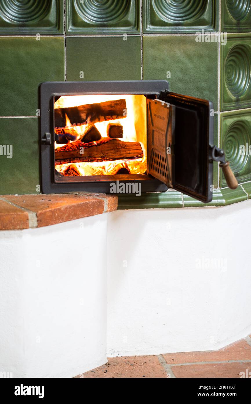 Fireplace with burning wood pile Stock Photo