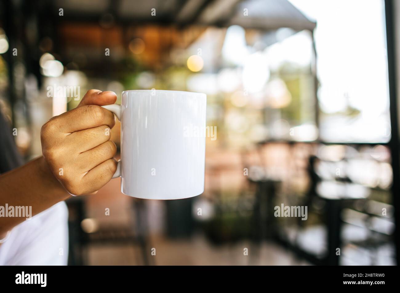 white cup on hand in relax time Stock Photo