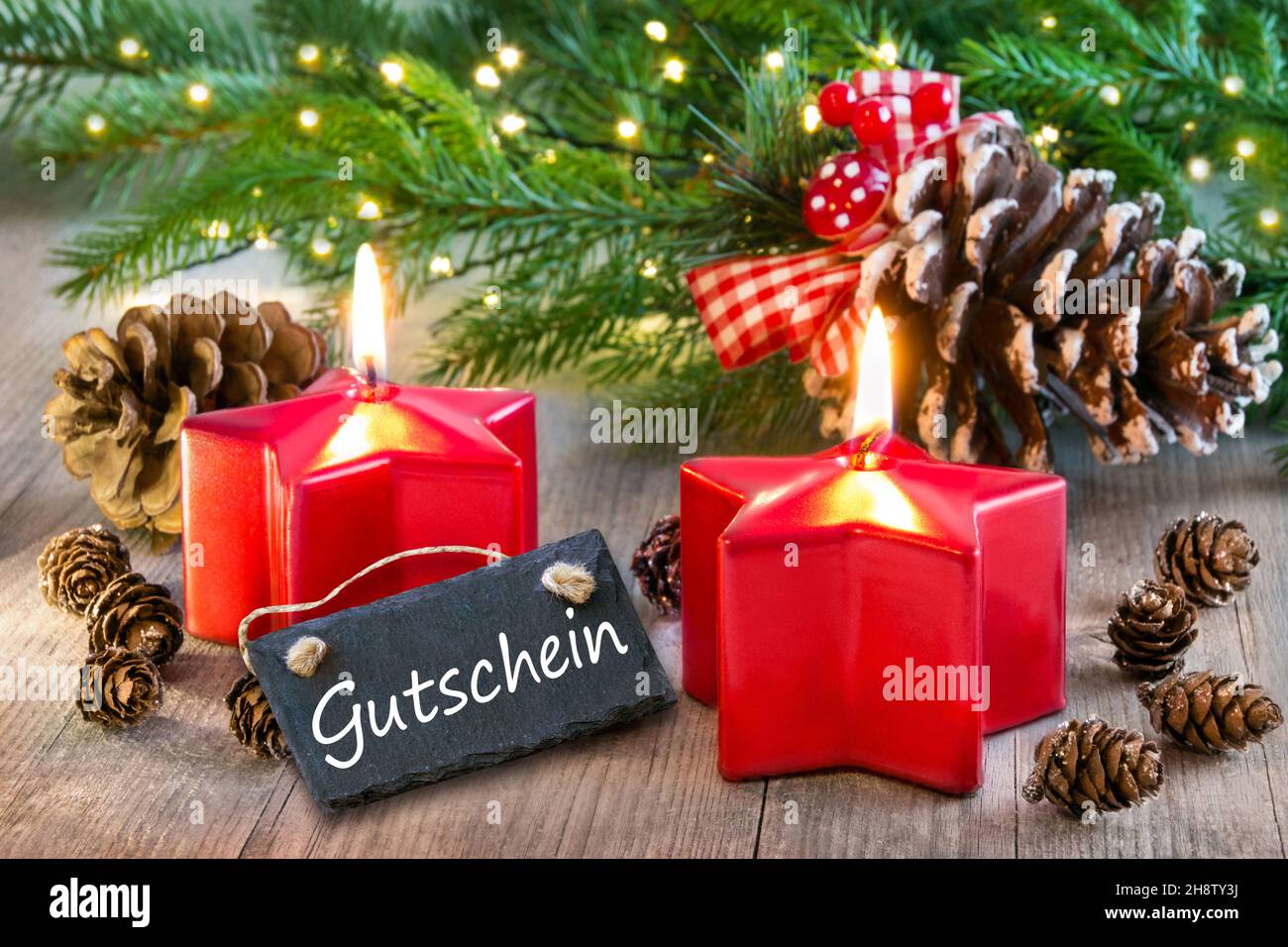 German Christmas Gift Voucher and decoration with candles Stock Photo
