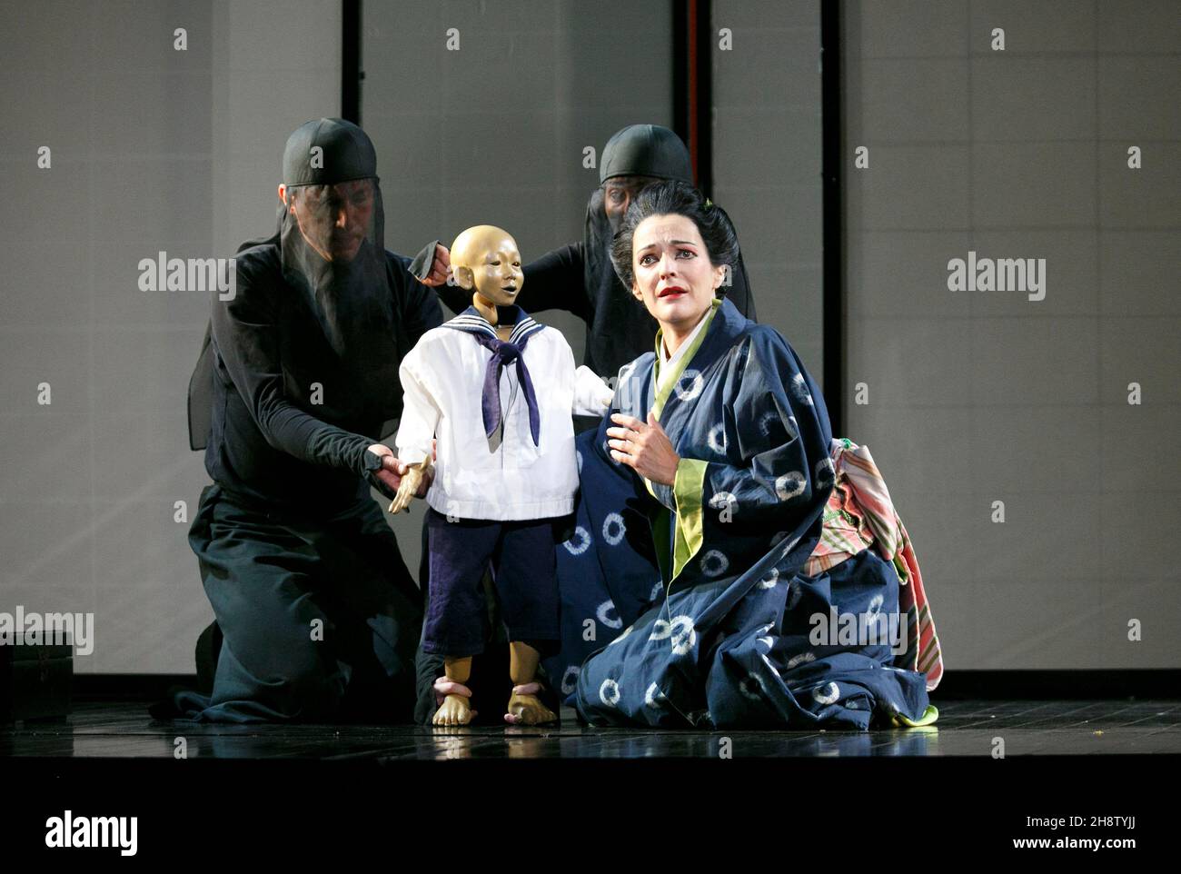 Pamela Helen Stephen (Suzuki - with a puppet of Sorrow) in MADAM BUTTERFLY by Puccini at English National Opera (ENO), London Coliseum, London WC2  14/10/2013 music: Giacomo Puccini  libretto: Luigi Illica and Giuseppe Giacosa  conductor: Gianluca Marciano  set design: Michael Levine  costumes: Han Feng  lighting: Peter Mumford  associate director & original choreographer: Carolyn Choa  original director: Anthony Minghella  revival director: Sarah Tipple Stock Photo