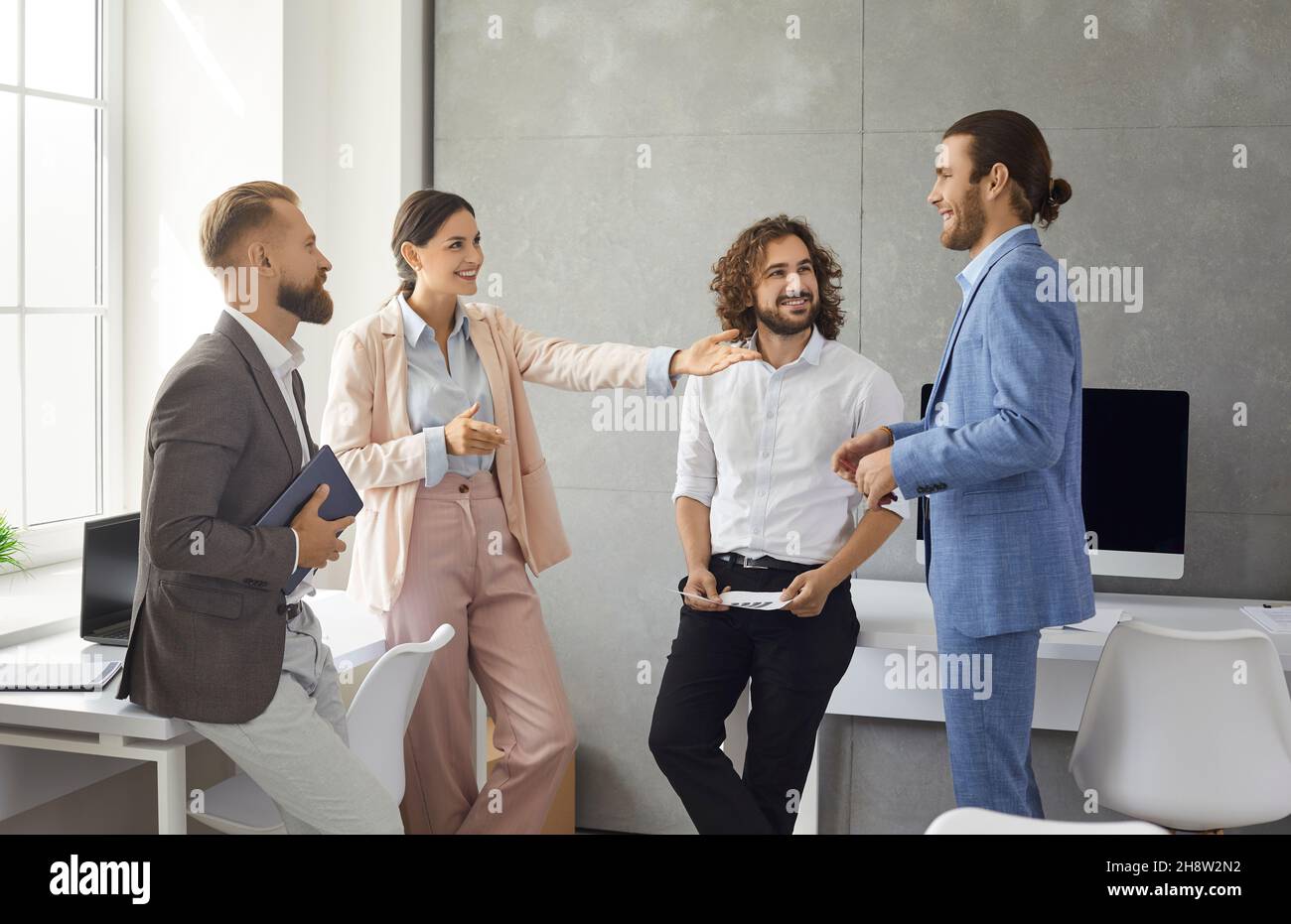 Smiling multiracial colleagues communicate brainstorm at workplace Stock Photo
