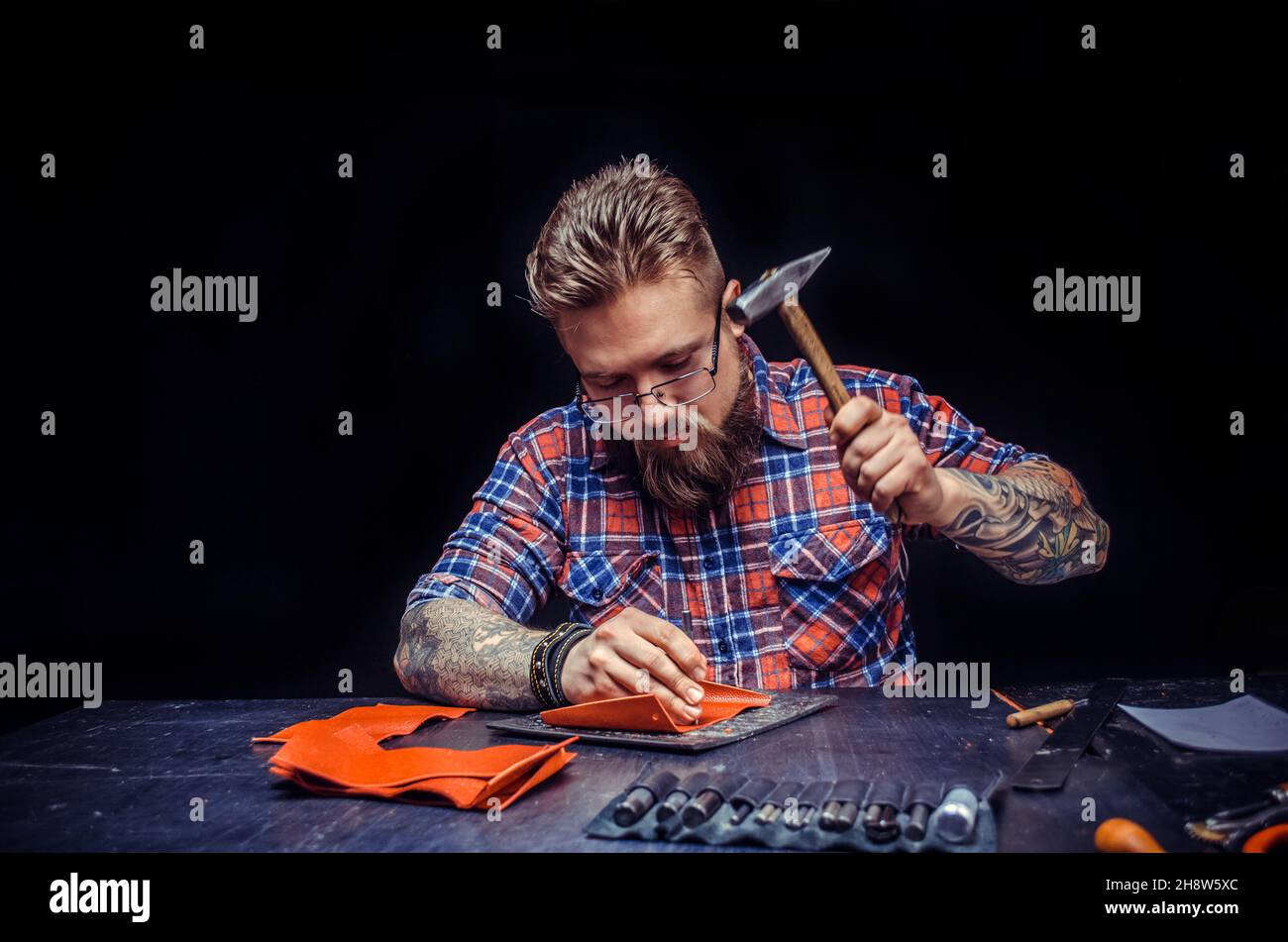 Worker of leather creating new leatherwork at studio Stock Photo