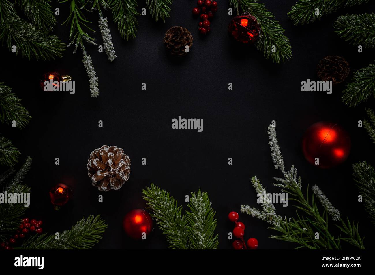 Christmas background with fir branches and red ball on dark and black ...