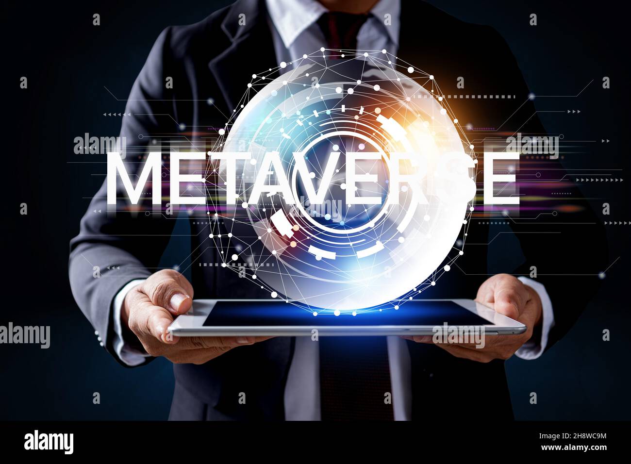 Trends of online connection metaverse businesses in 2022, hand of businessman holding world of the internet technology network and tablet. Stock Photo