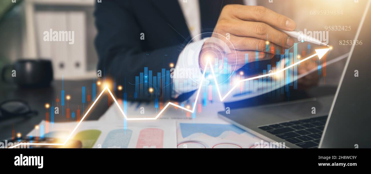 Financial business profit and digital economic growing up, hand of business man holding tablet and check digital graph and chart of cryptocurrency Stock Photo