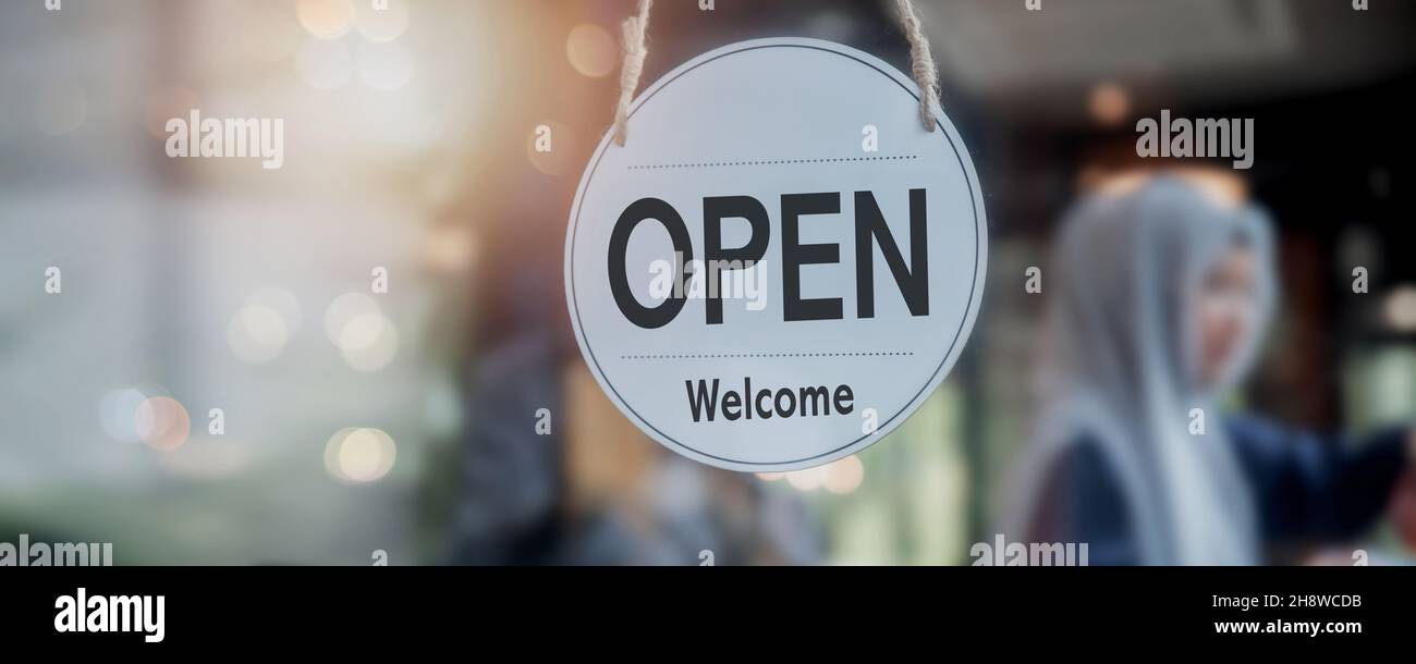 open sign in front of door café and shop, new normal and start business concept during coronavirus or Covid-19 Stock Photo