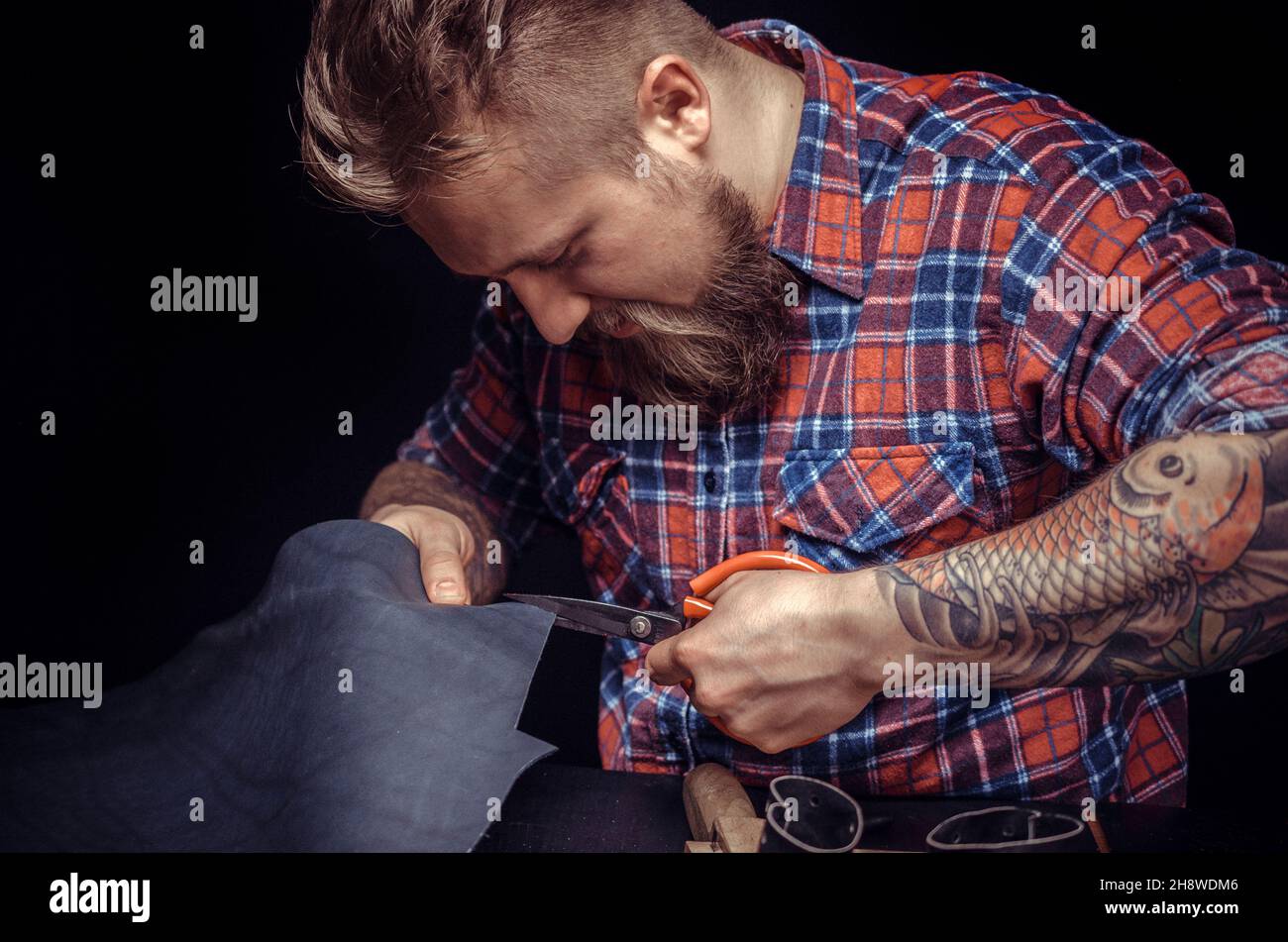 Leather Professional creating new leatherwork Stock Photo