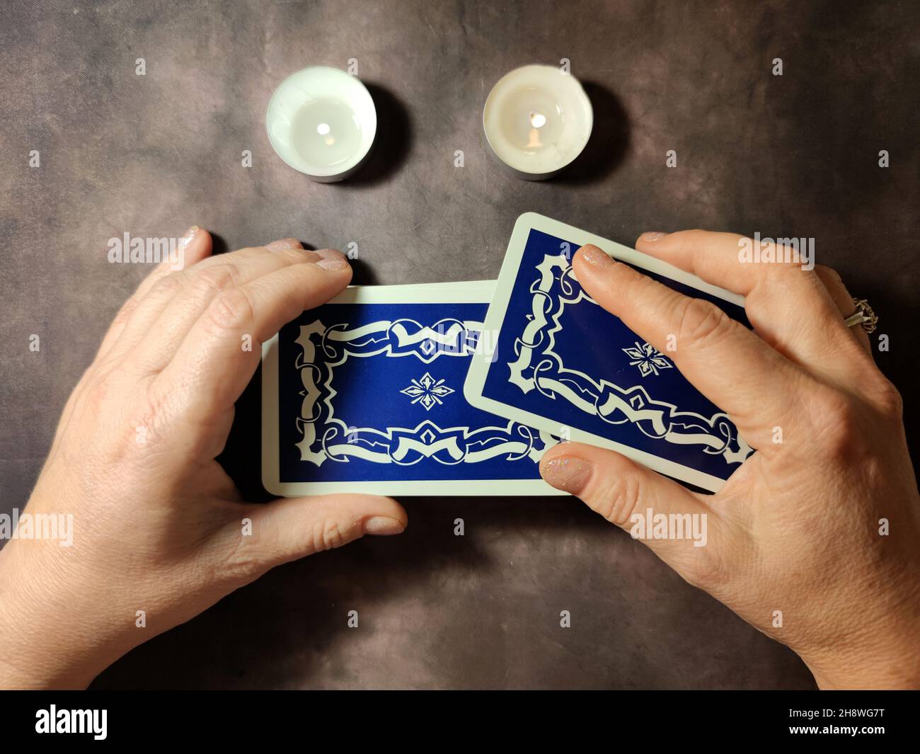 female hands shuffle tarot cards, solitaire layout close-up Stock Photo -  Alamy