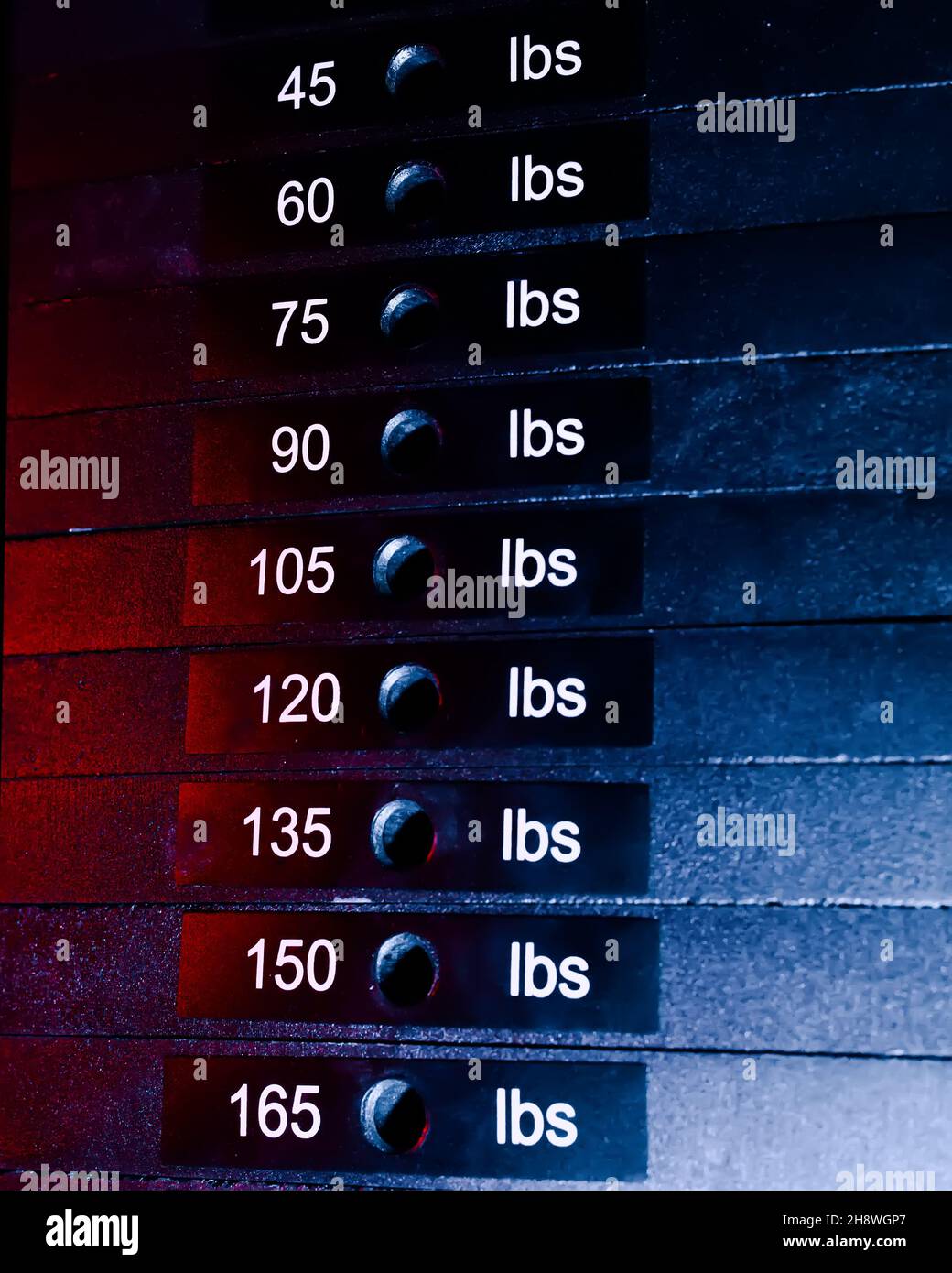 A cargo block on a sports simulator with numbers and weight. sports equipment close-up. Dark background Stock Photo