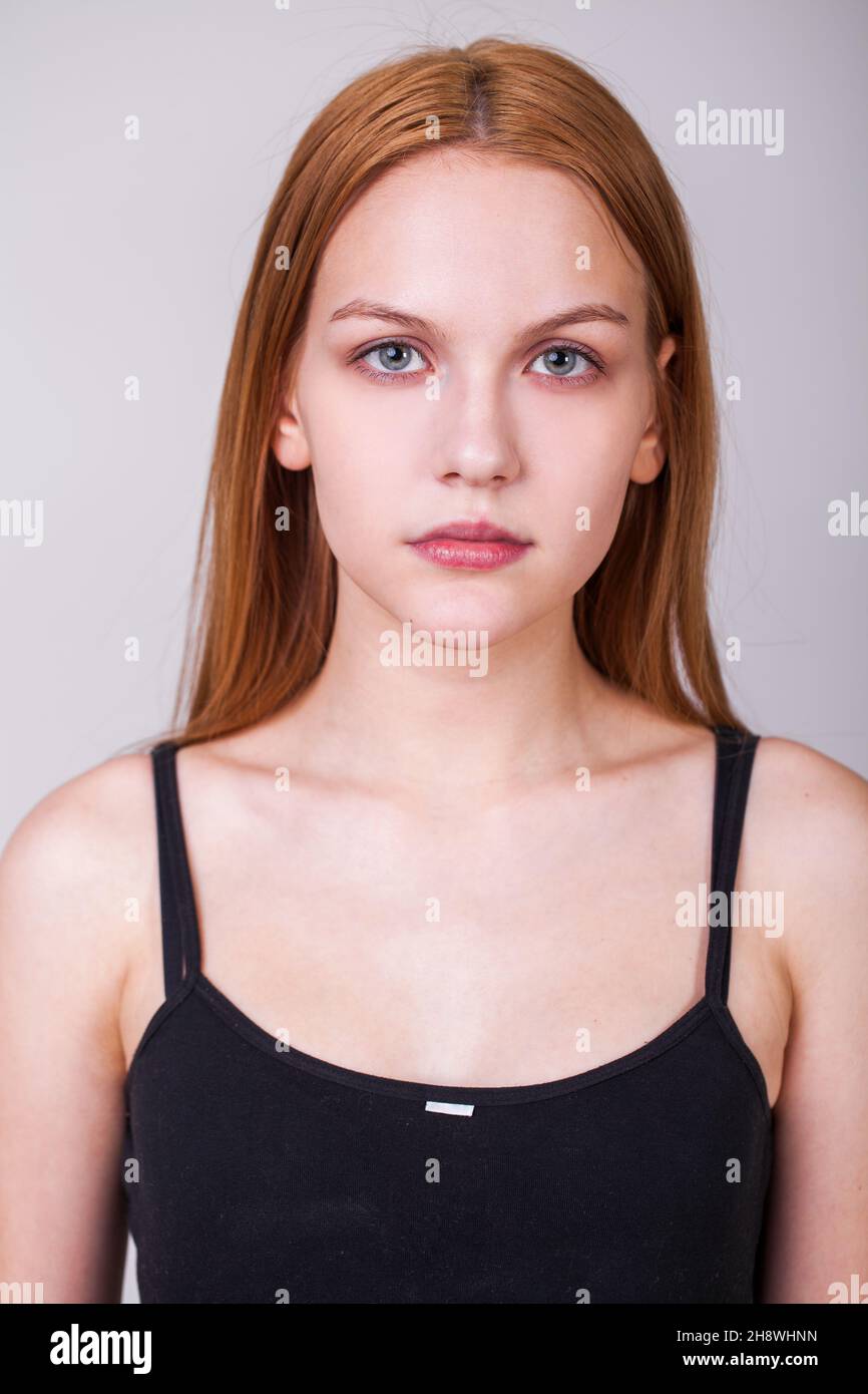 Close up portrait of a young beautiful blonde model, isolated on gray ...