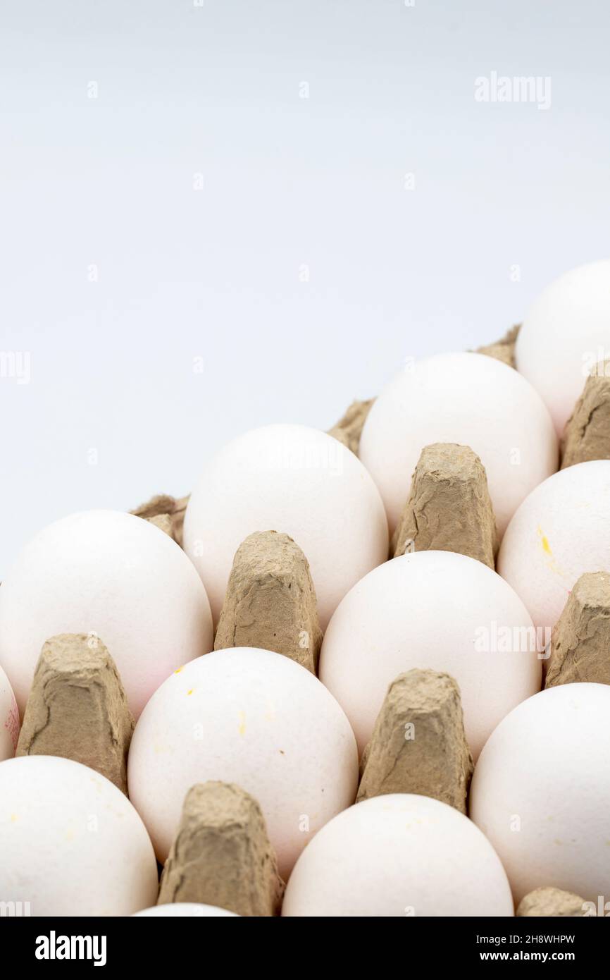 Eggs in a carton on a white background. Vertical view. close up Stock Photo