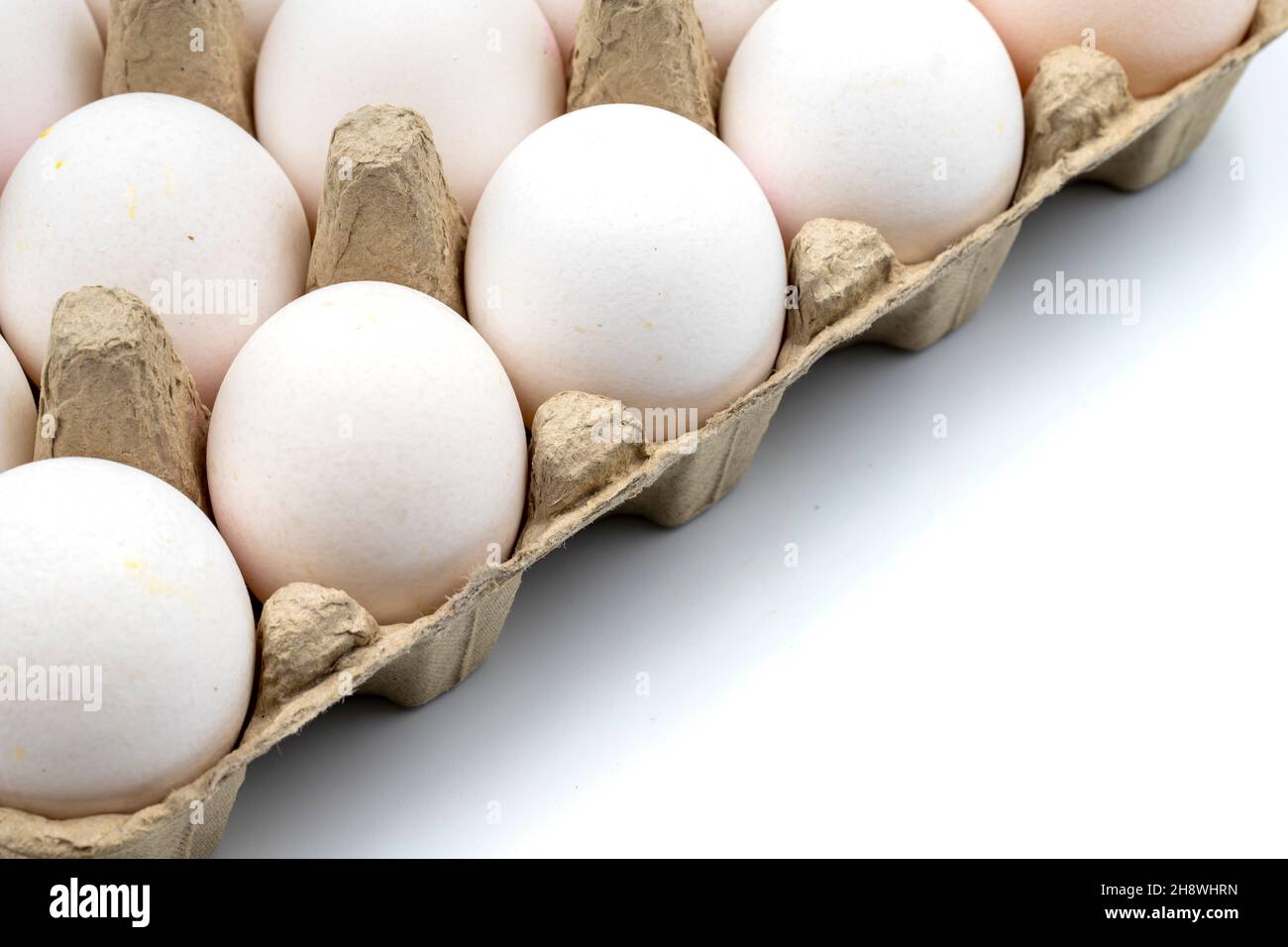Eggs in a carton on a white background. horizontal view. close up Stock Photo