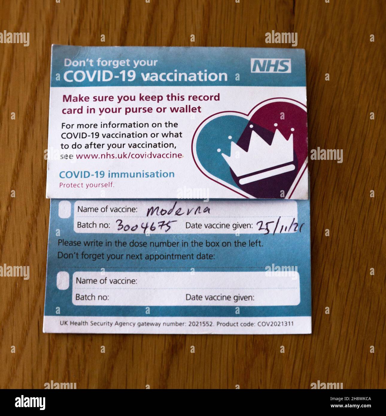 An NHS (UK) Moderna Vaccination Certificate. Stock Photo