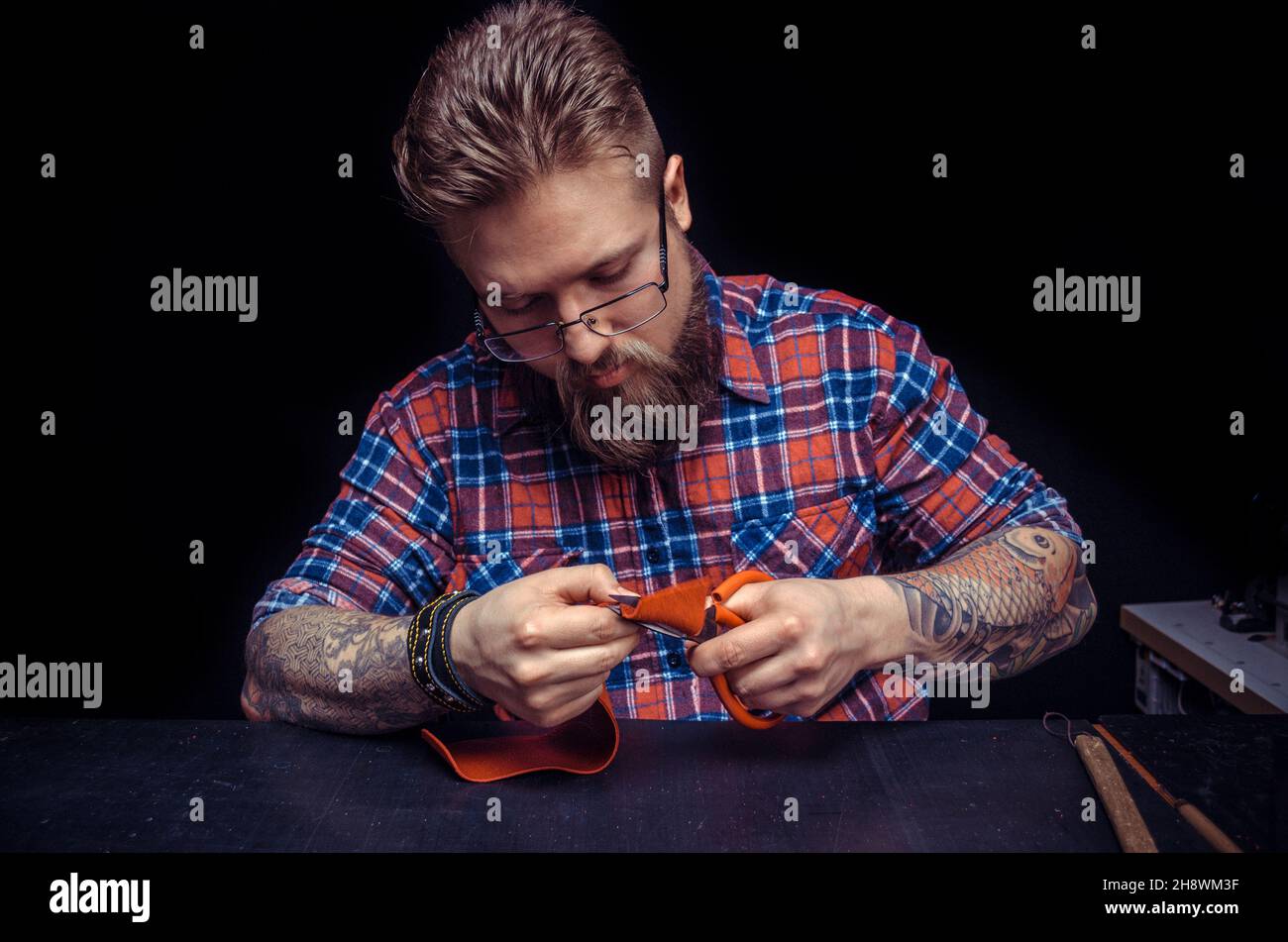 Leather Professional creating new leatherwork Stock Photo