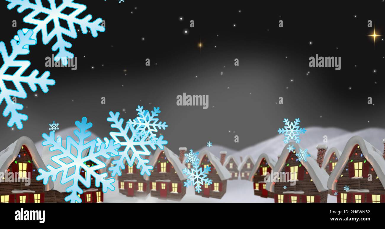 Composition of snowflakes and snow covered houses against star field at night, copy space Stock Photo