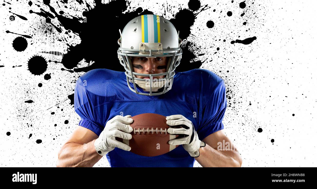 Digital composite of confident american football player holding ball against splattered background Stock Photo