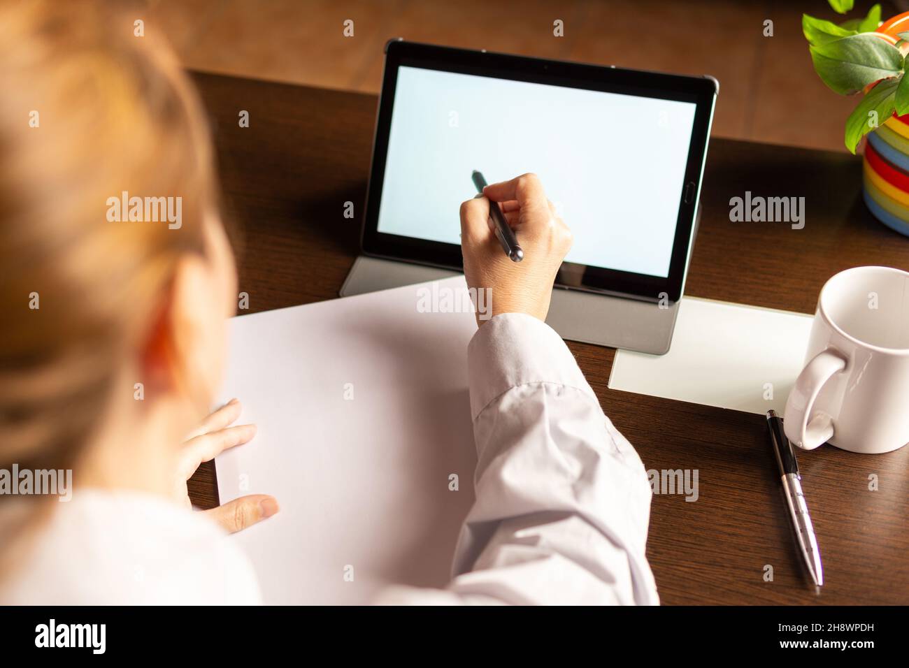 Woman using digital tablet with digital pencil, businesswoman or student. Working from home concept Stock Photo