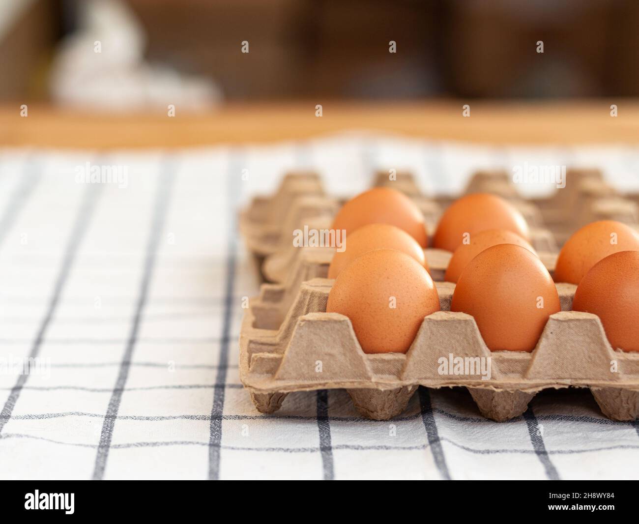 Few brown eggs among the cells of a large cardboard bag, chicken egg as a valuable nutritious product, a tray for carrying and storing fragile eggs. N Stock Photo