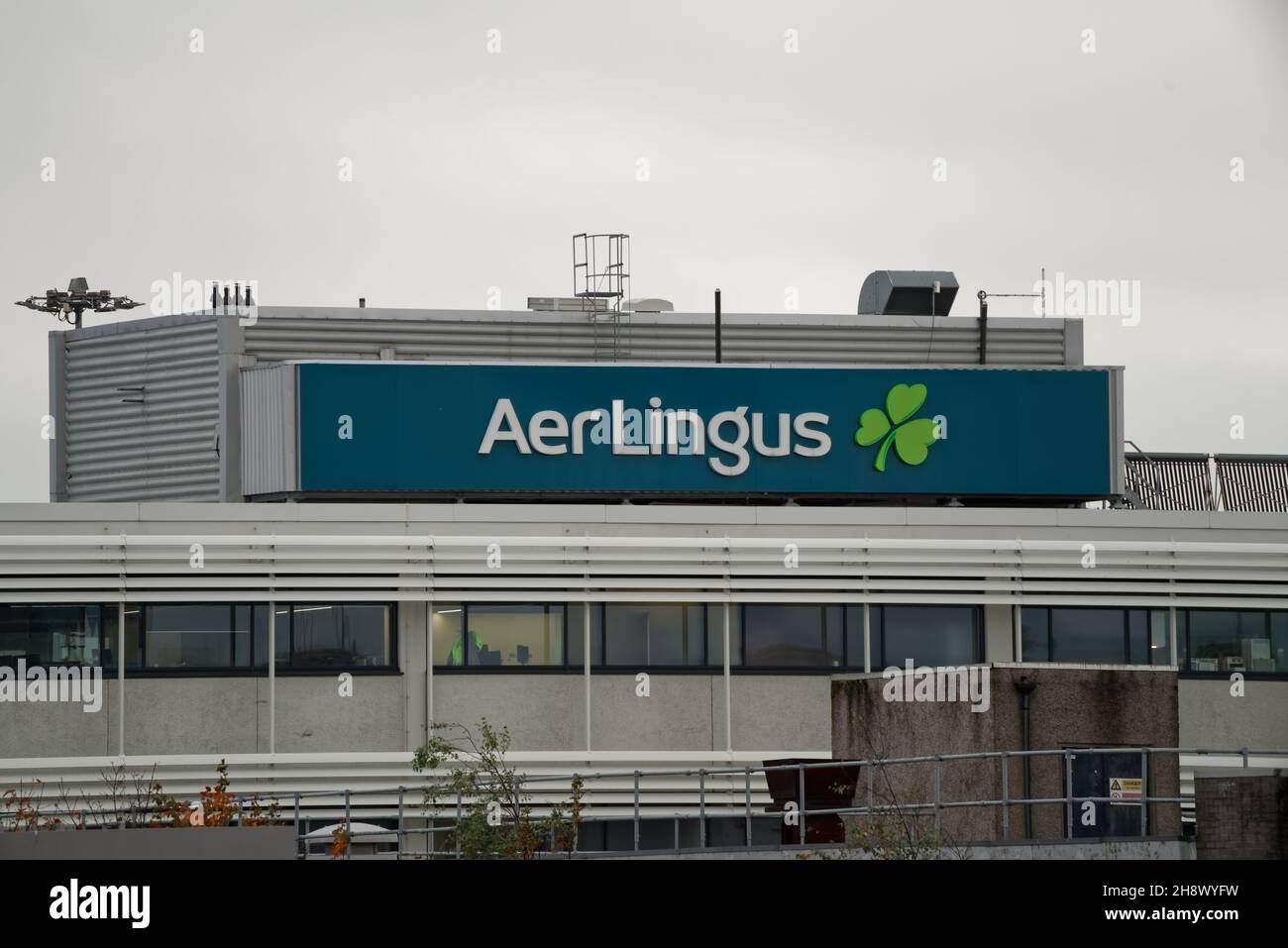 DUBLIN, IRELAND - Nov 11, 2021: Closeup shot of Aer Lingus name with green shamrock logo on the building at Dublin Airport. The Aer Lingus is the flag Stock Photo