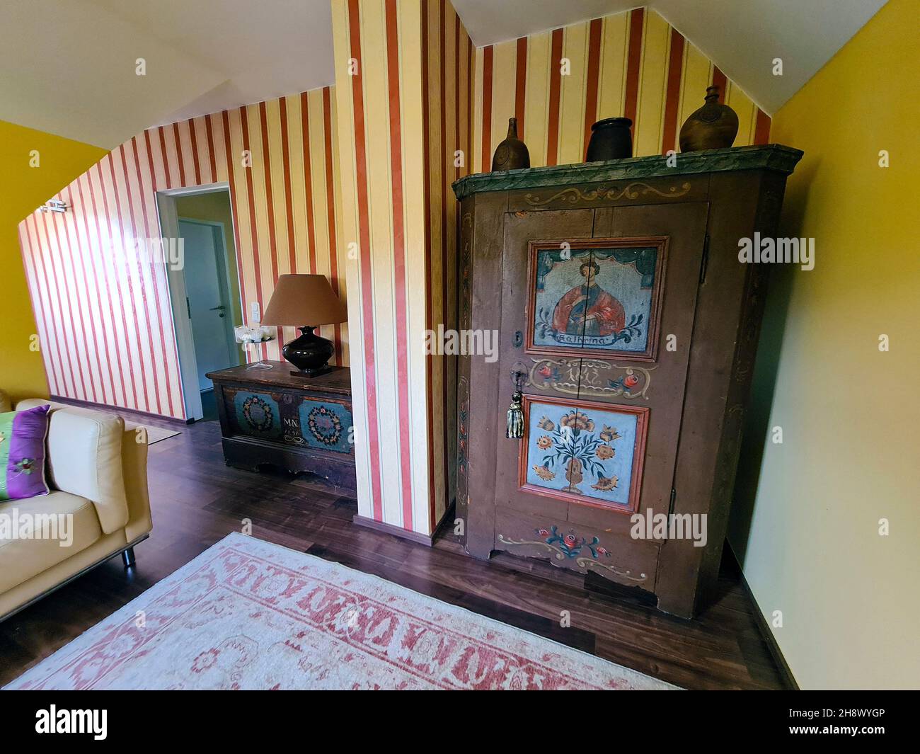Austria, modern room combined with old painted furniture, wardrobe and chest of drawers from the 19th century Stock Photo