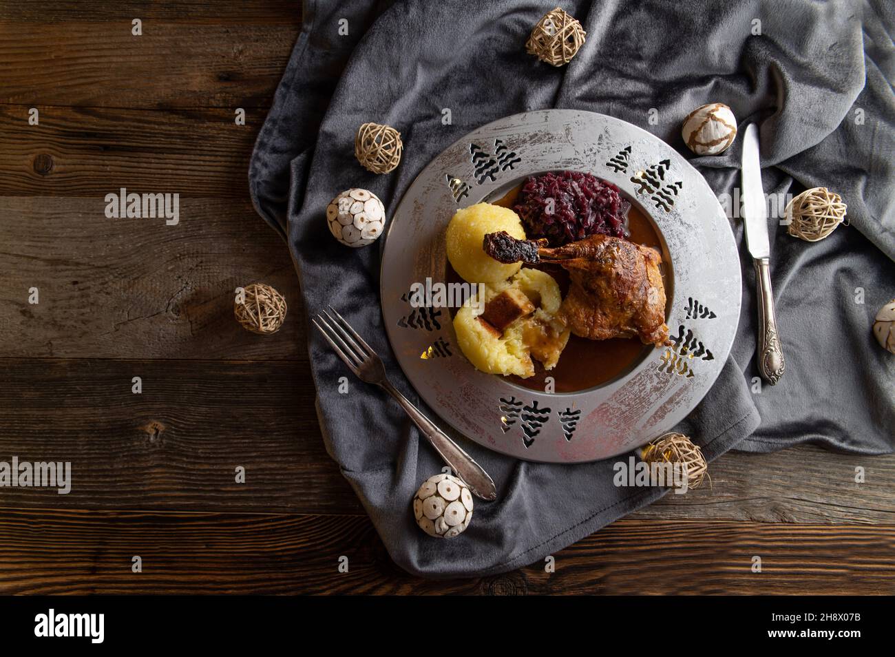 German traditional christmas meal on a plate with roasted duck leg, red