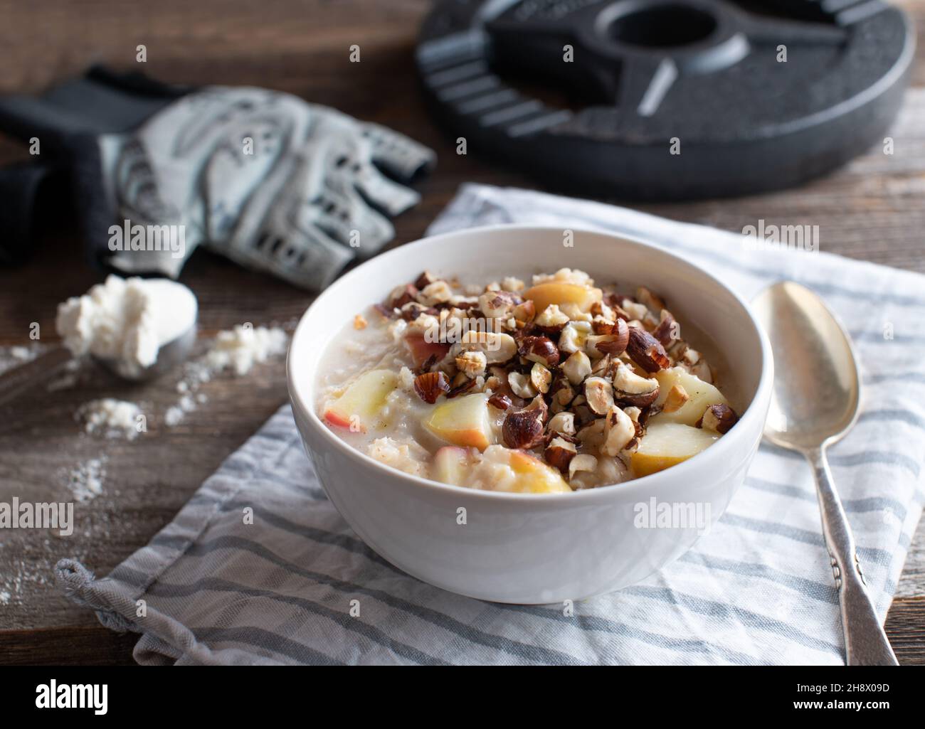 Fitness breakfast bowl for muscle building with a fresh cooked oatmeal porridge, whey protein